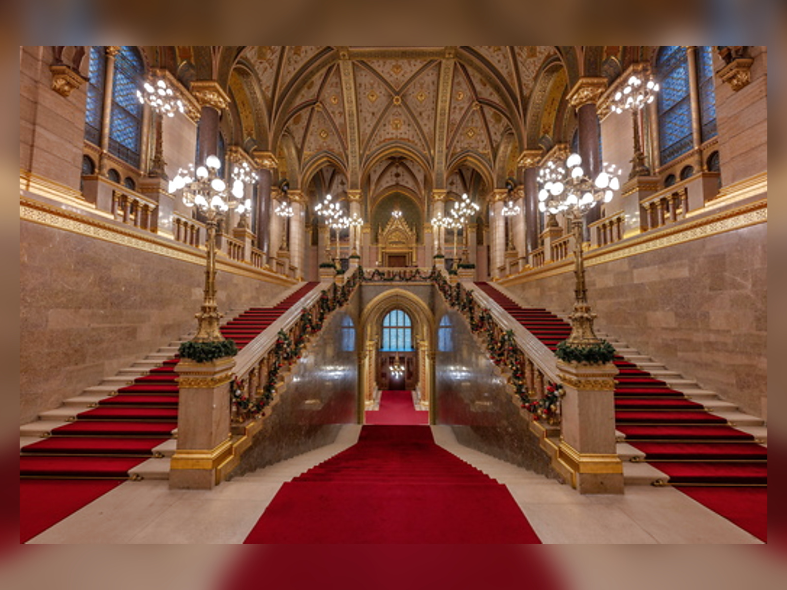 The Grand Staircase with red carpet and gilded ceilings